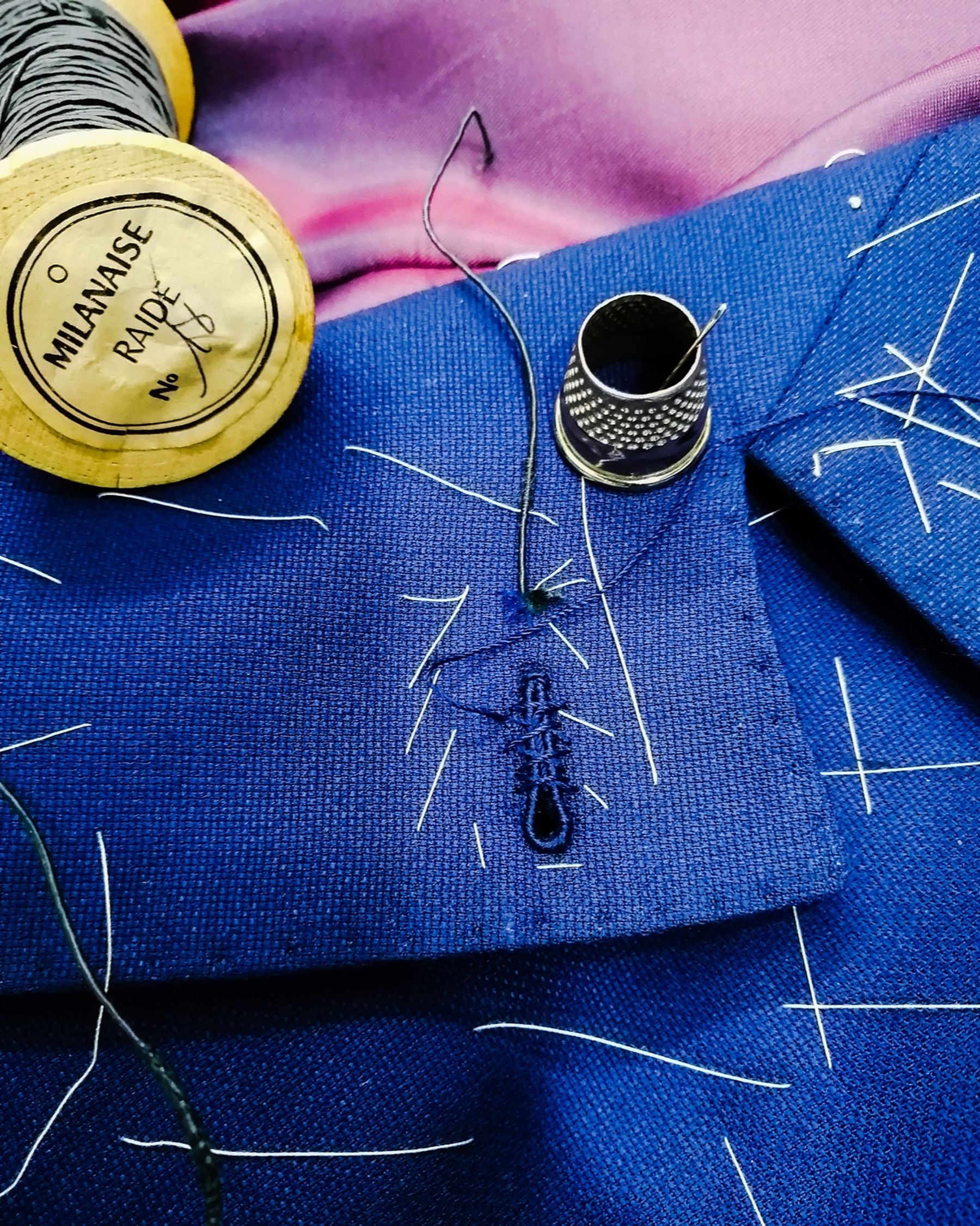 The first stitches of a hand-made Milanese buttonhole