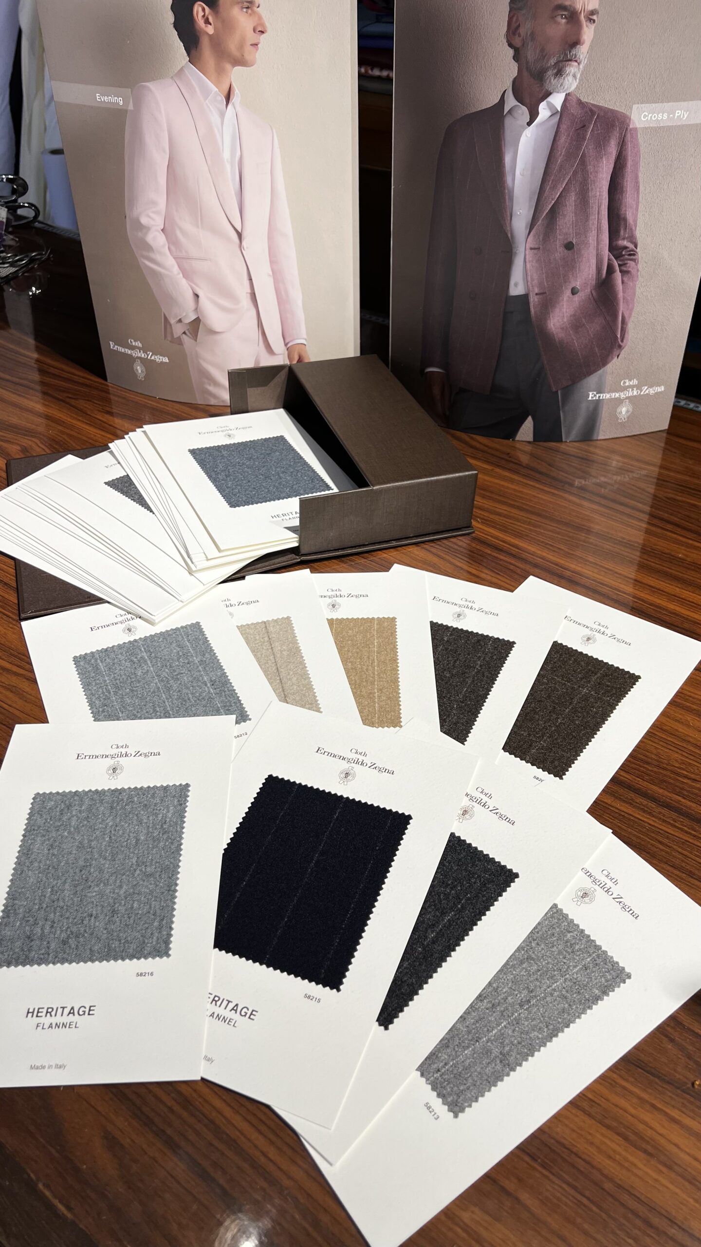article / bespoke fabrics Zegna fabric swatch cards on an atelier desk